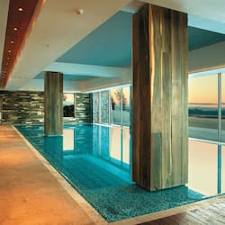 Relax by the pool with a clear view of the surrounding landscape.