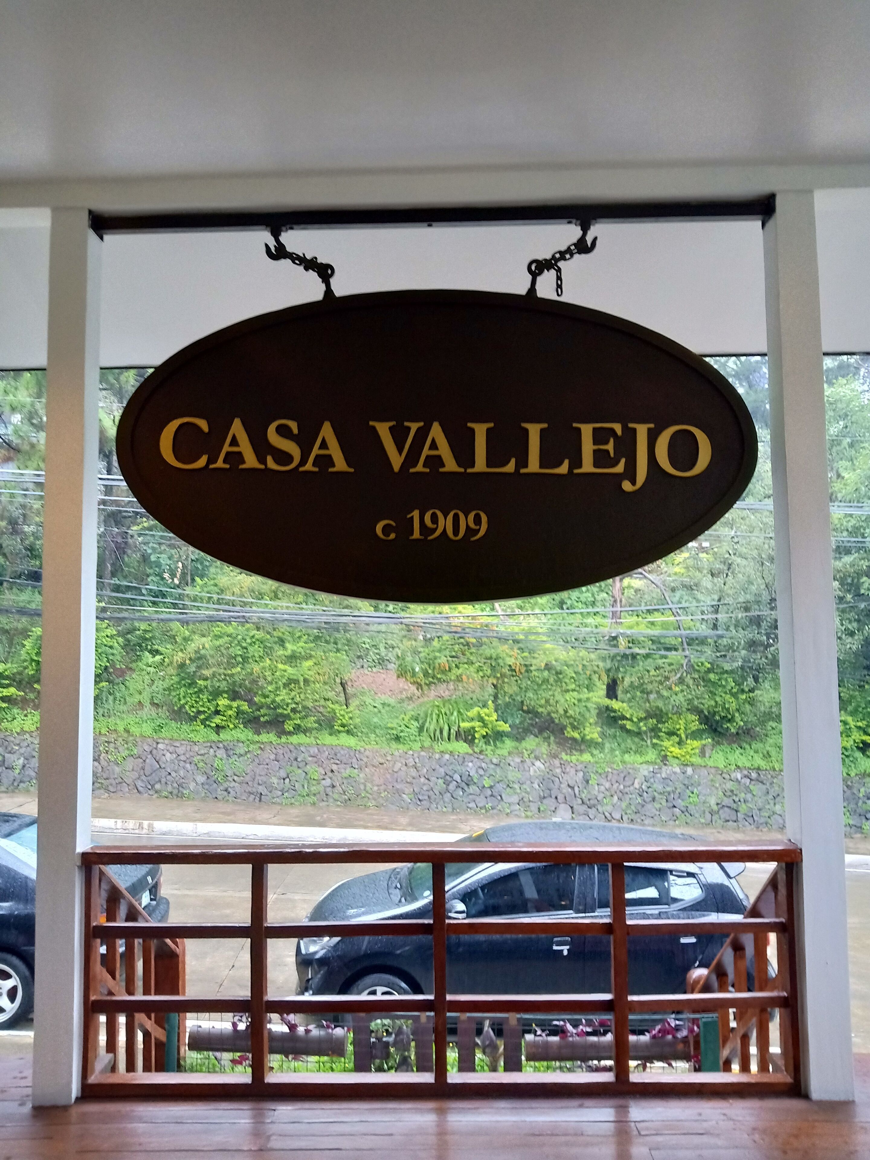 A sign reading "CASA VALLEJO c 1909" hanging from a window.