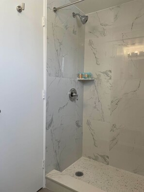 Family Room, Multiple Beds, Kitchenette, Garden View | Bathroom | Shower, free toiletries, hair dryer, towels