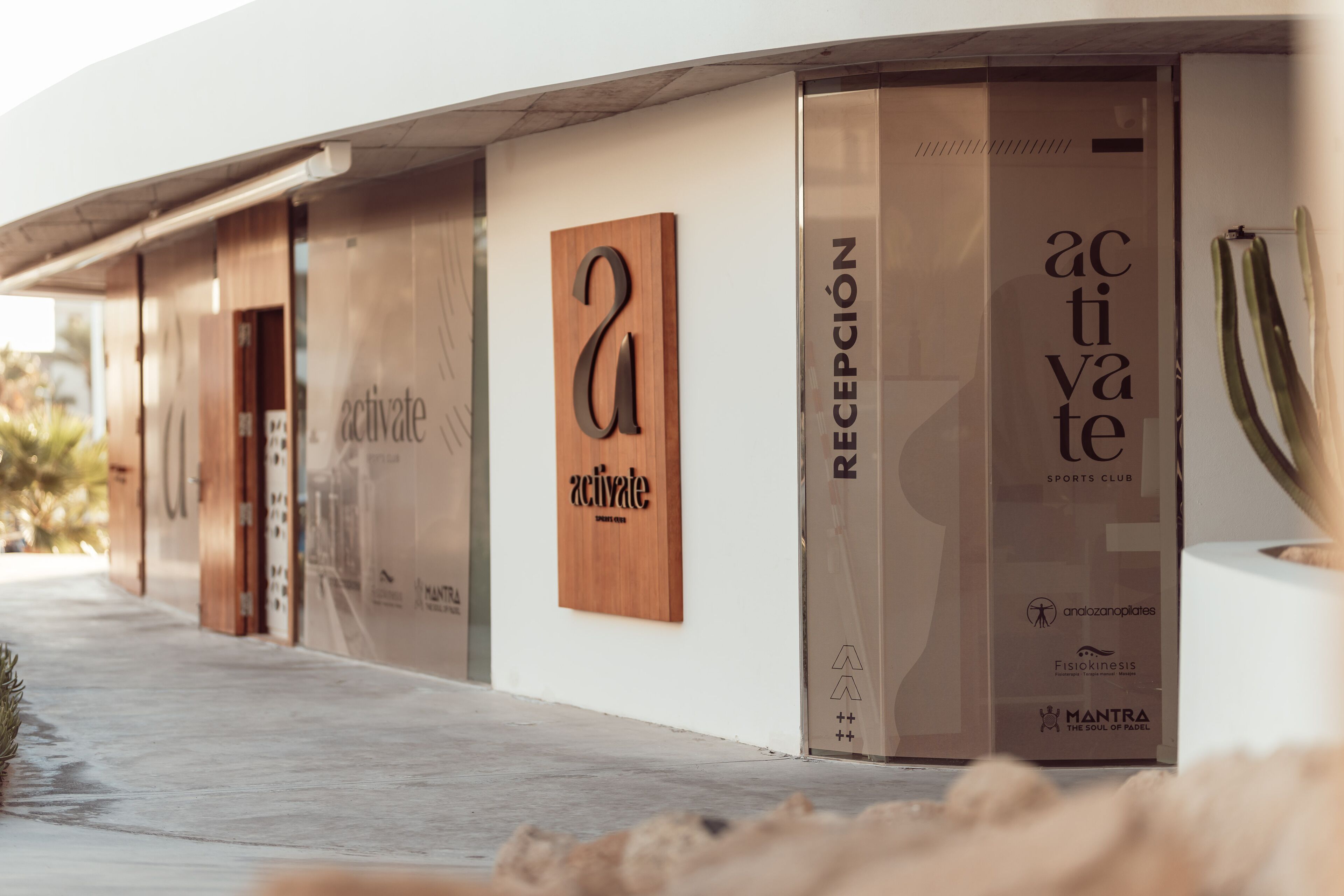 Fachada moderna de edificio con grandes paneles de madera que muestran la palabra "activate" y el nombre "activite".
