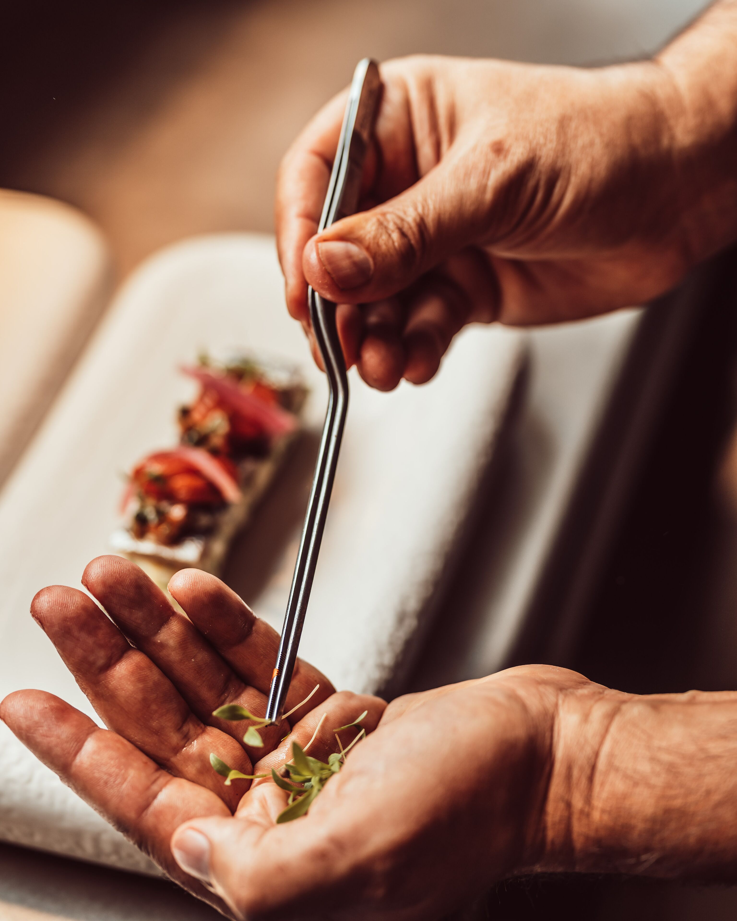 A person holding a fork with a piece of food.