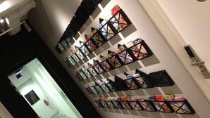 Un pasillo con un estante de libros en la pared y una puerta con cerradura.