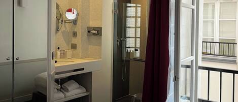 A modern bathroom with a shower, a sink, and a toilet.