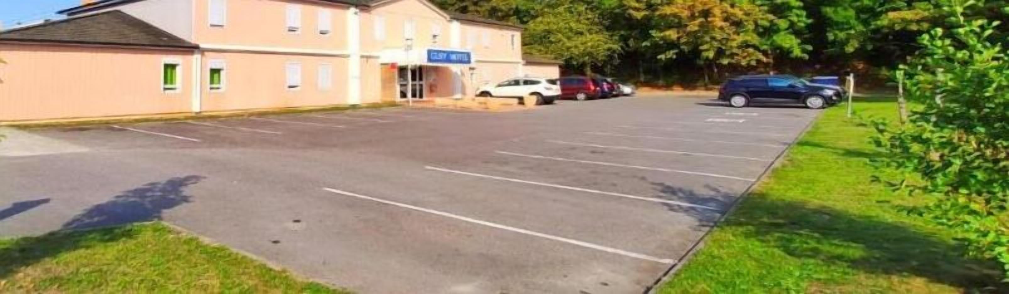 A parking lot with a building labeled "GILLY HOTEL" in the background.