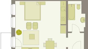 Planta baixa de um quarto de hotel com cama, escrivaninha, cadeira, mesinha de centro, sofá e banheiro com banheira, vaso sanitário e pia.