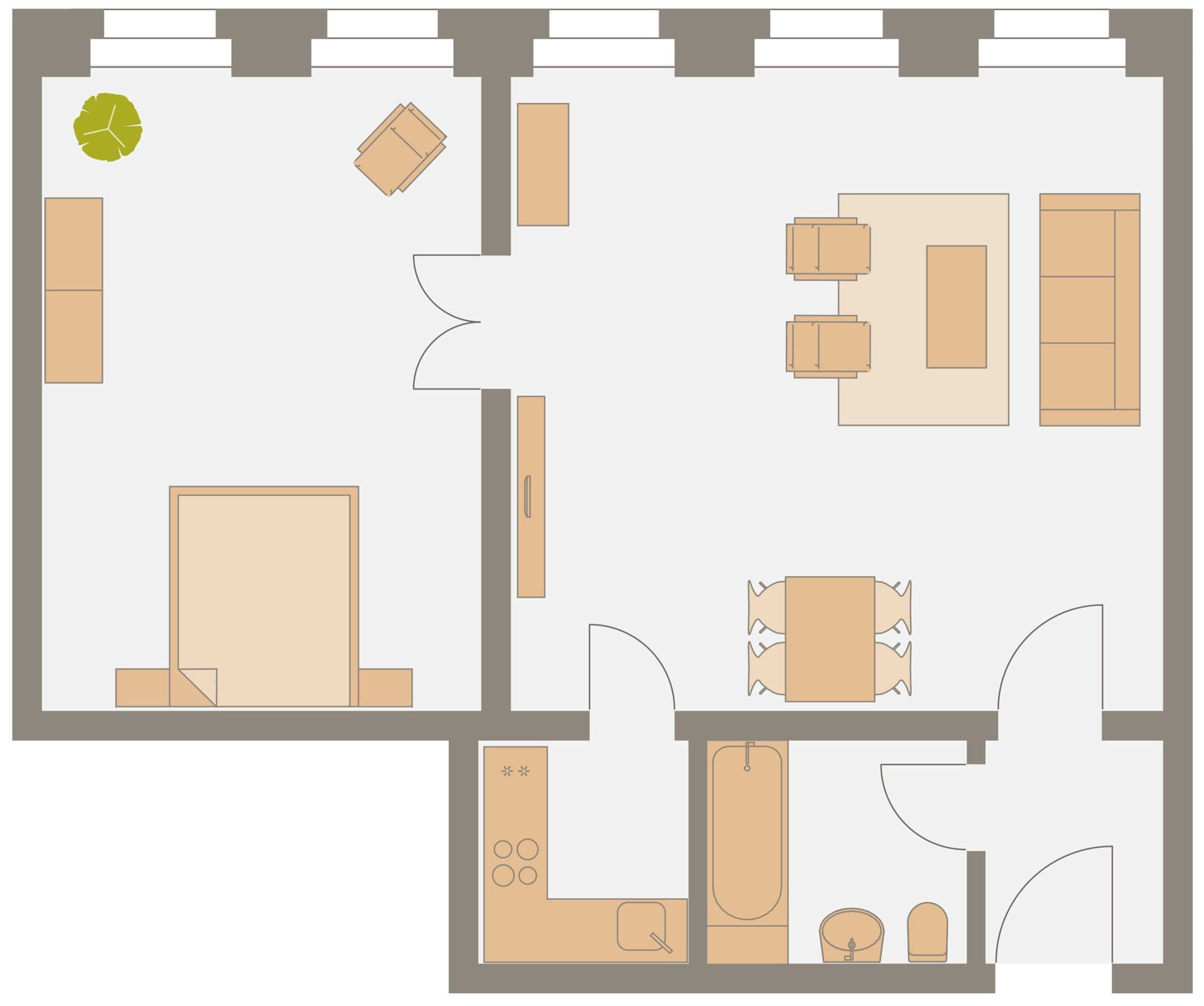 Un plan d’étage comprenant une grande chambre, une salle de bain, un coin repas et un salon.