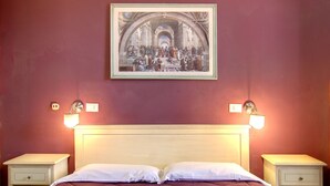 A hotel room with a large bed, two bedside tables, a framed artwork above the bed, and wall-mounted light fixtures. - Hotel Genzianella (Florence)