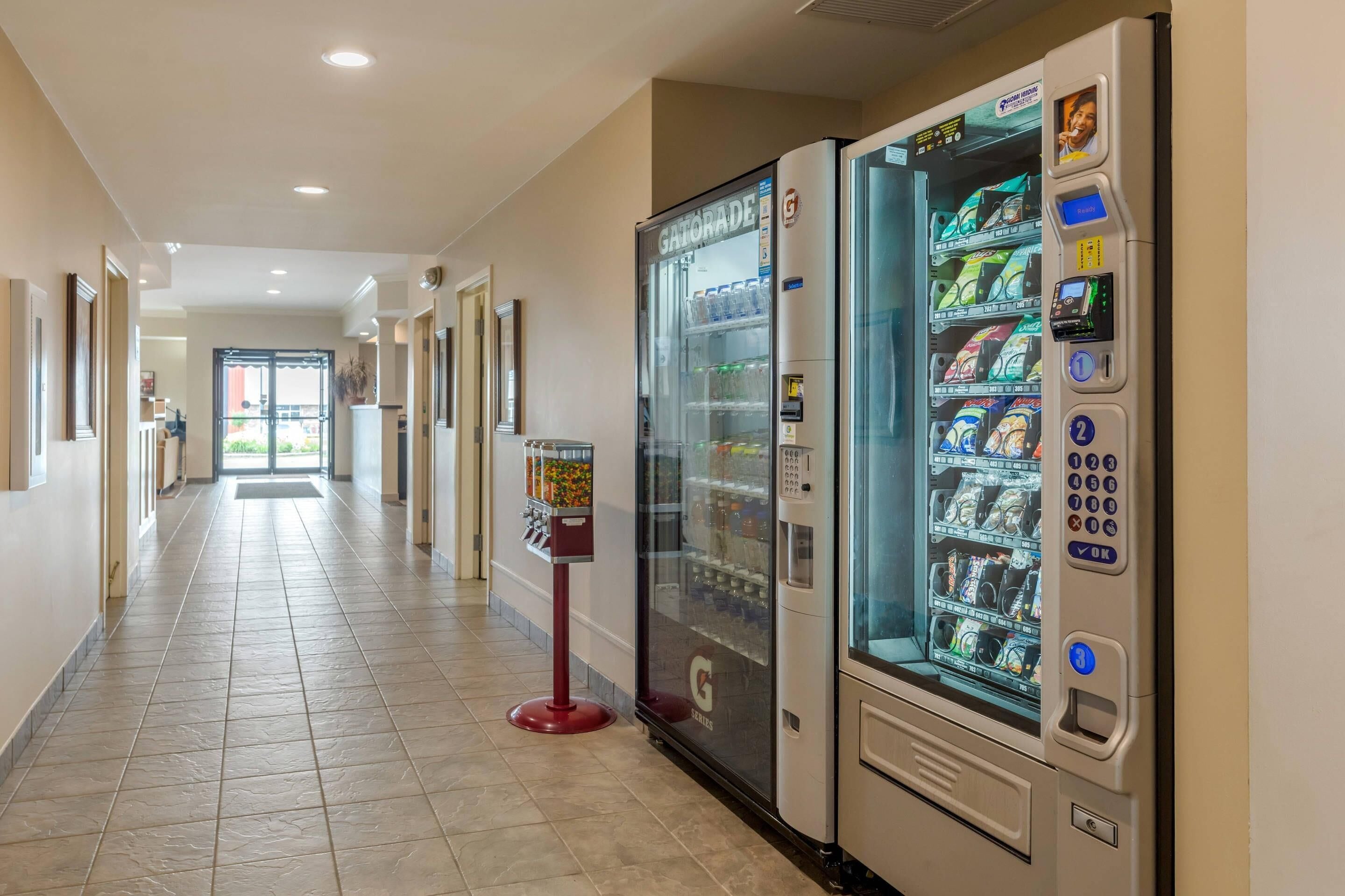 A hallway with vending machines and a snack dispenser.