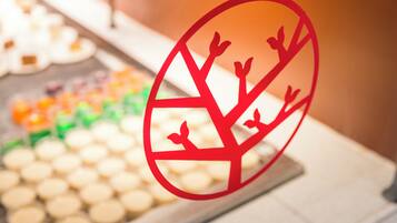 A close-up of a dessert display with a red sign featuring a tree design.