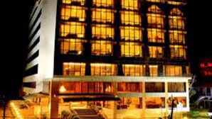 A multi-story building with illuminated windows at night, a visible entrance, and a staircase leading to the entrance. - Classic Sarovar Portico Thiruvananthapuram (Thiruvananthapuram)