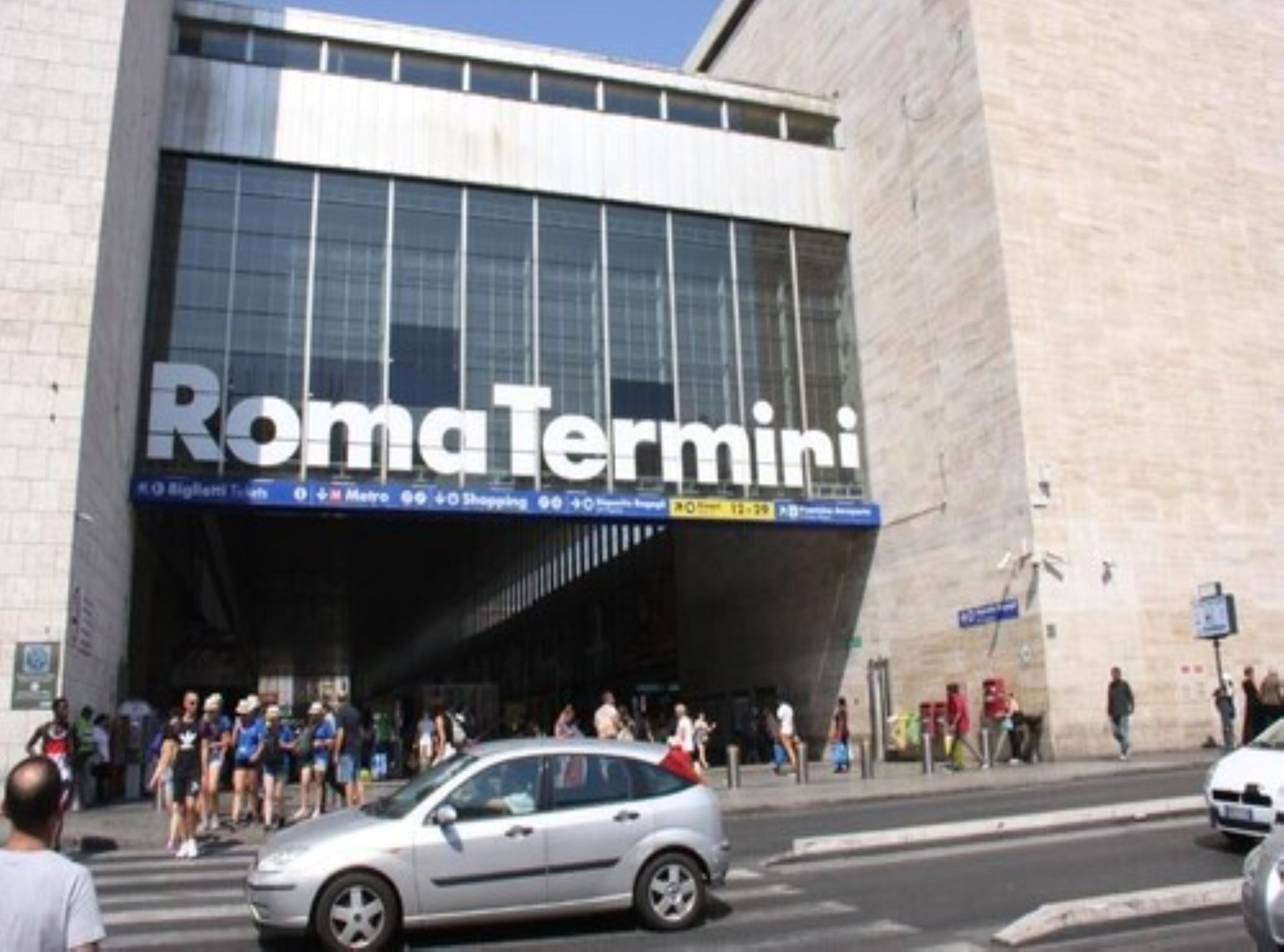 A modern building with a large sign reading "RomaTermini".