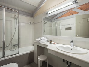 A modern bathroom with a glass-enclosed shower, a white sink, and a large mirror. - Villa Andromeda (Chania)