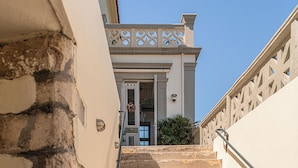 A staircase leading to a building with a white facade and decorative railings. - Villa Andromeda (Chania)