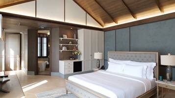 A spacious bedroom with a large bed, built-in shelving, and a wooden ceiling.