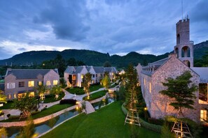 A large estate with multiple buildings, a pond, and a tower. - Thames Valley Khao Yai (Pak Chong)