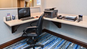 A hotel workspace with a desk, computer, printer, and office chair. - Holiday Inn Express & Suites York by IHG (York)