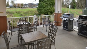An outdoor patio with a grill, seating, and a view of the surrounding area. - Candlewood Suites Eugene Springfield by IHG (Eugene)