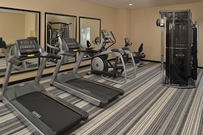 A hotel fitness center with treadmills, elliptical machines, and a weight machine. - Candlewood Suites Eugene Springfield by IHG (Eugene)