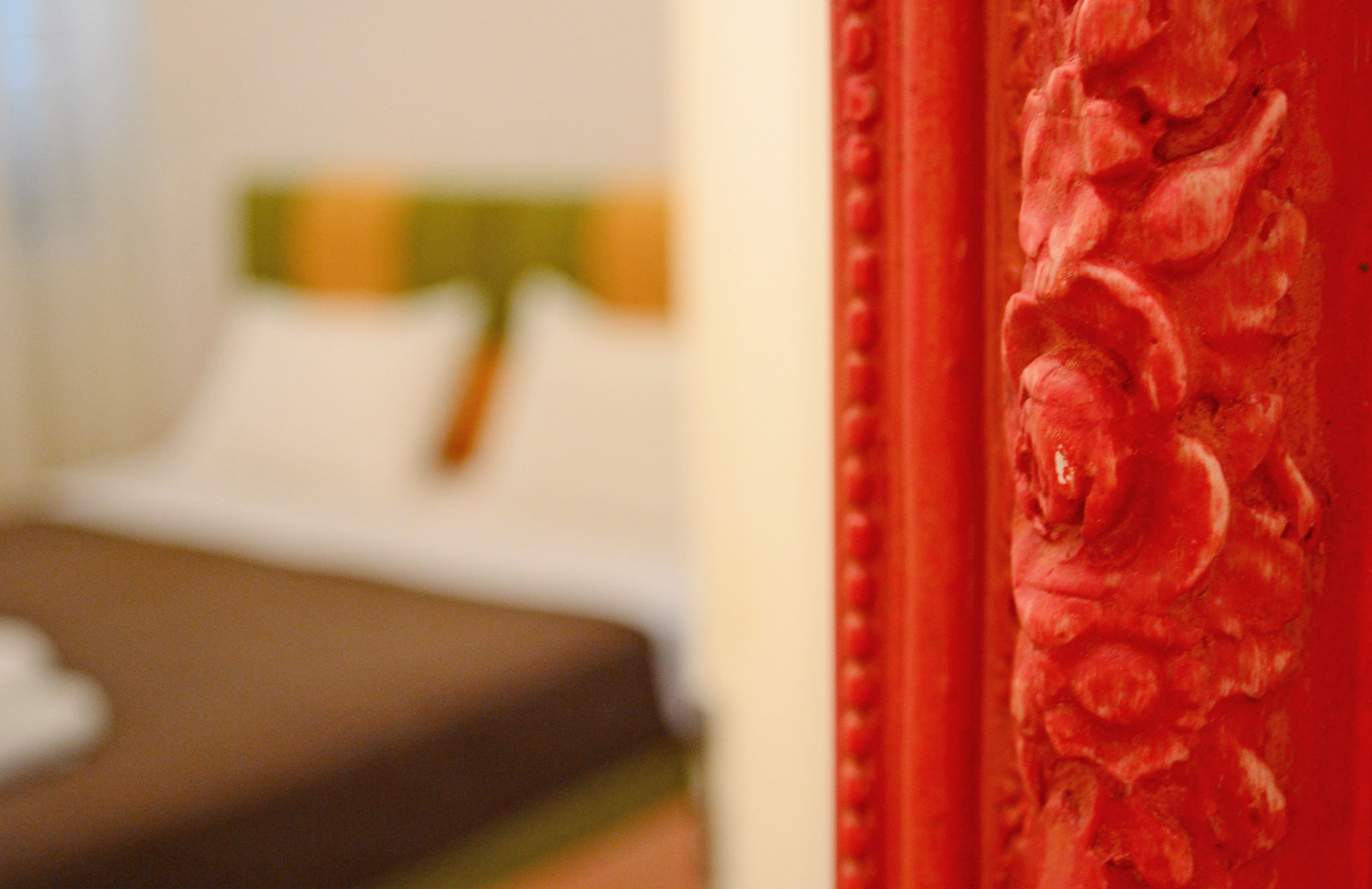 A close-up of a red curtain with floral patterns.