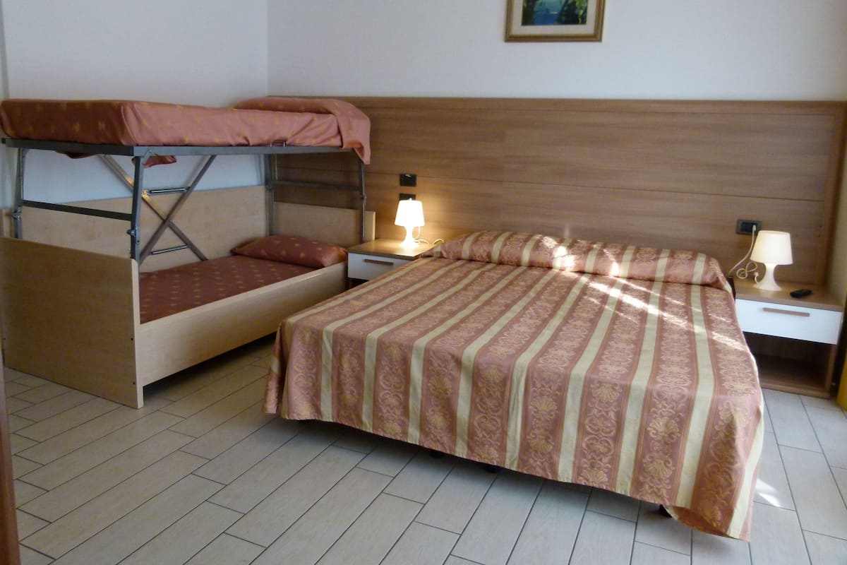 Quadruple Room | Minibar, in-room safe, individually decorated, individually furnished