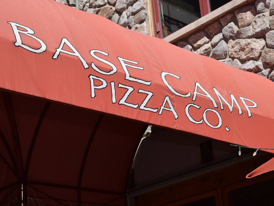 A red umbrella with "BASE CAMP PIZZA CO." written on it.