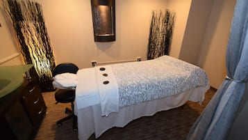 Relax in a cozy space with a comfortable bed, a desk for work, and a chair for unwinding.