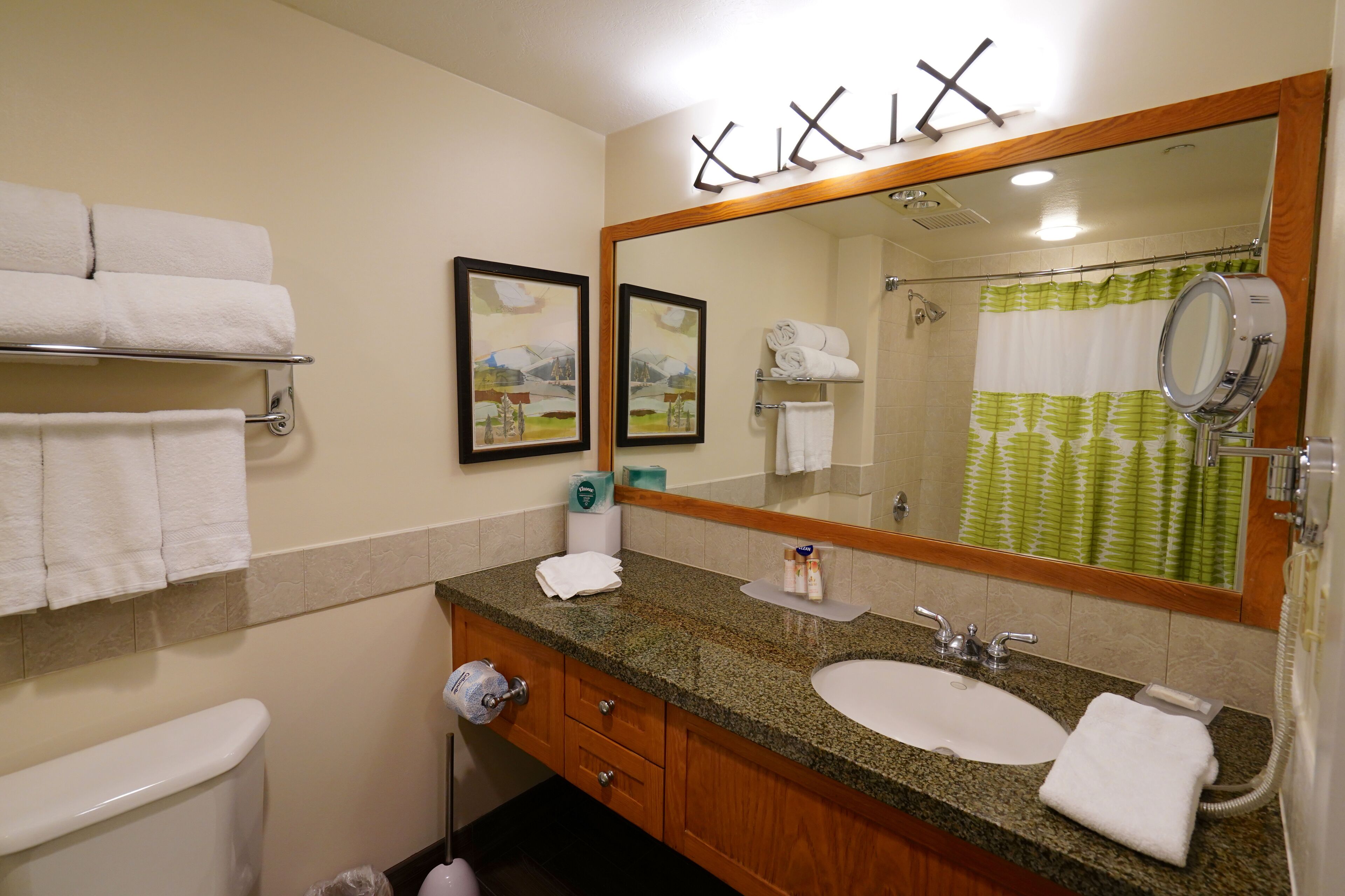 A bathroom with a sink, mirror, and towel rack.