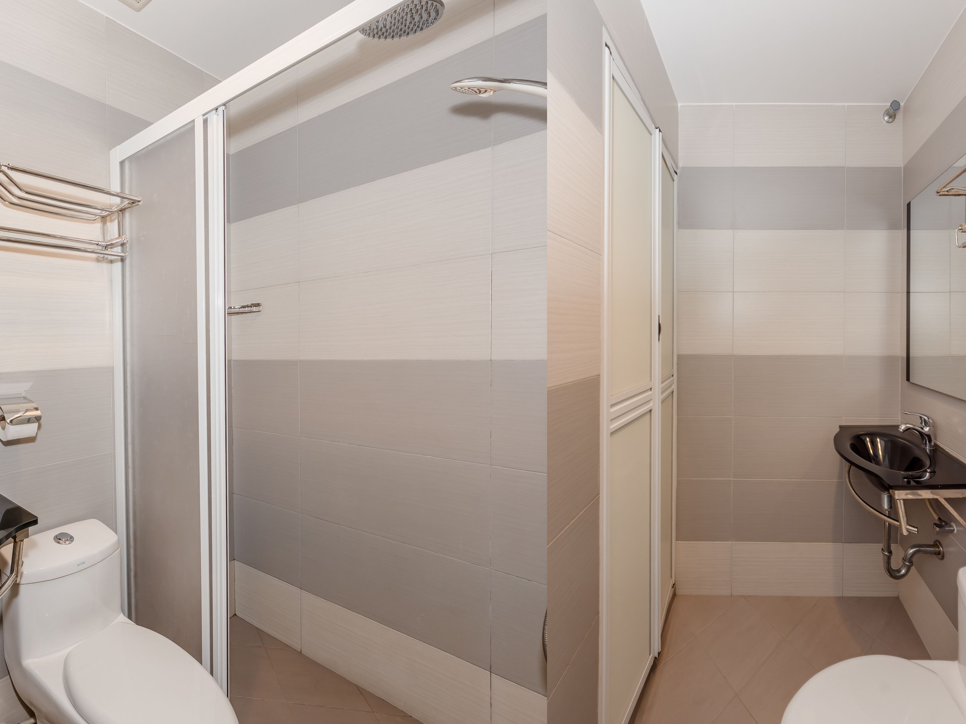 A modern bathroom with a shower, toilet, and sink.