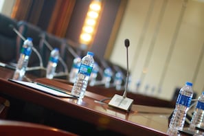 A conference room with a long table, microphones, and water bottles. - Holiday Inn Express Luoyang City Center by IHG (Luoyang)