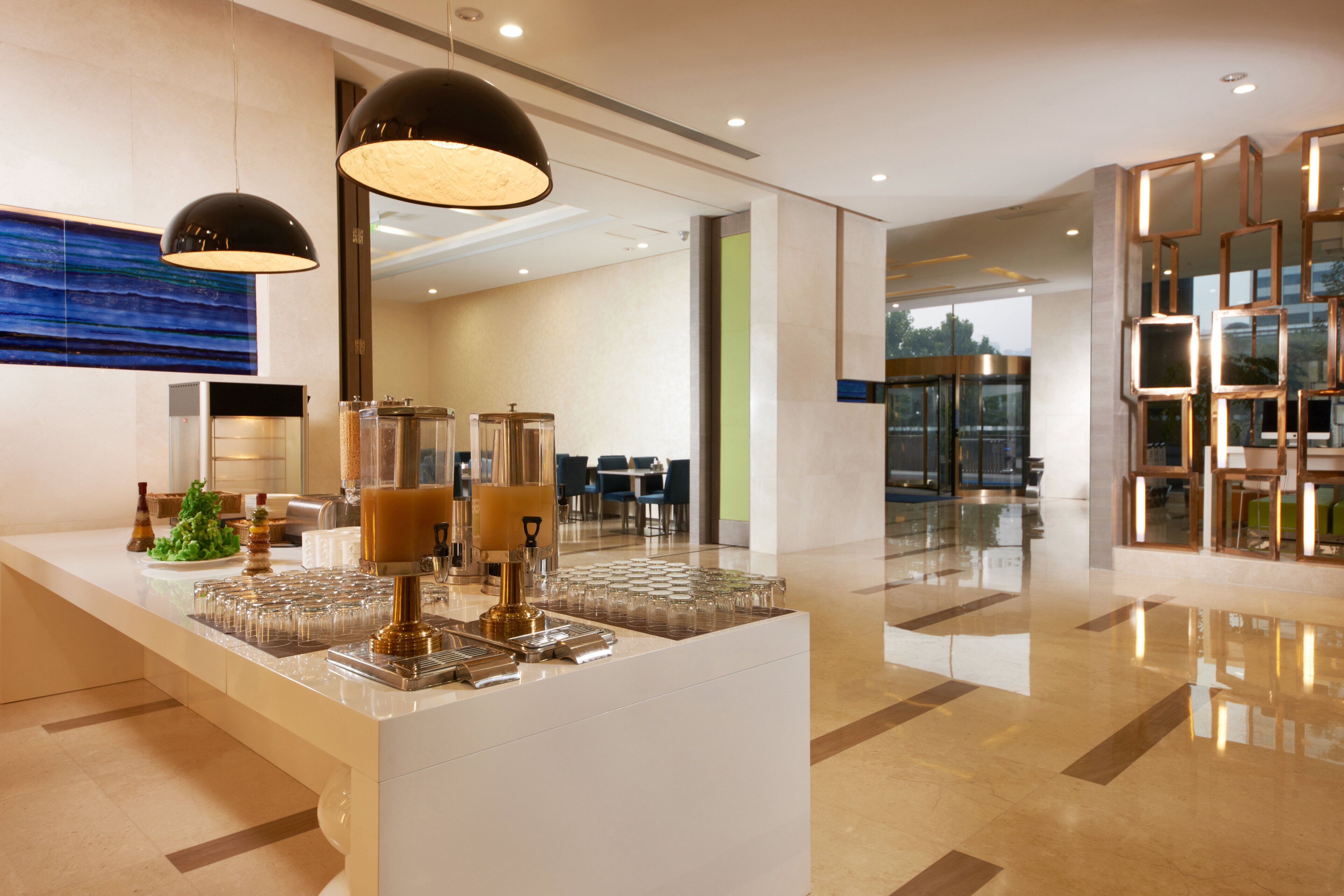 A modern bar area with a central island, bar stools, and a seating area in the background.