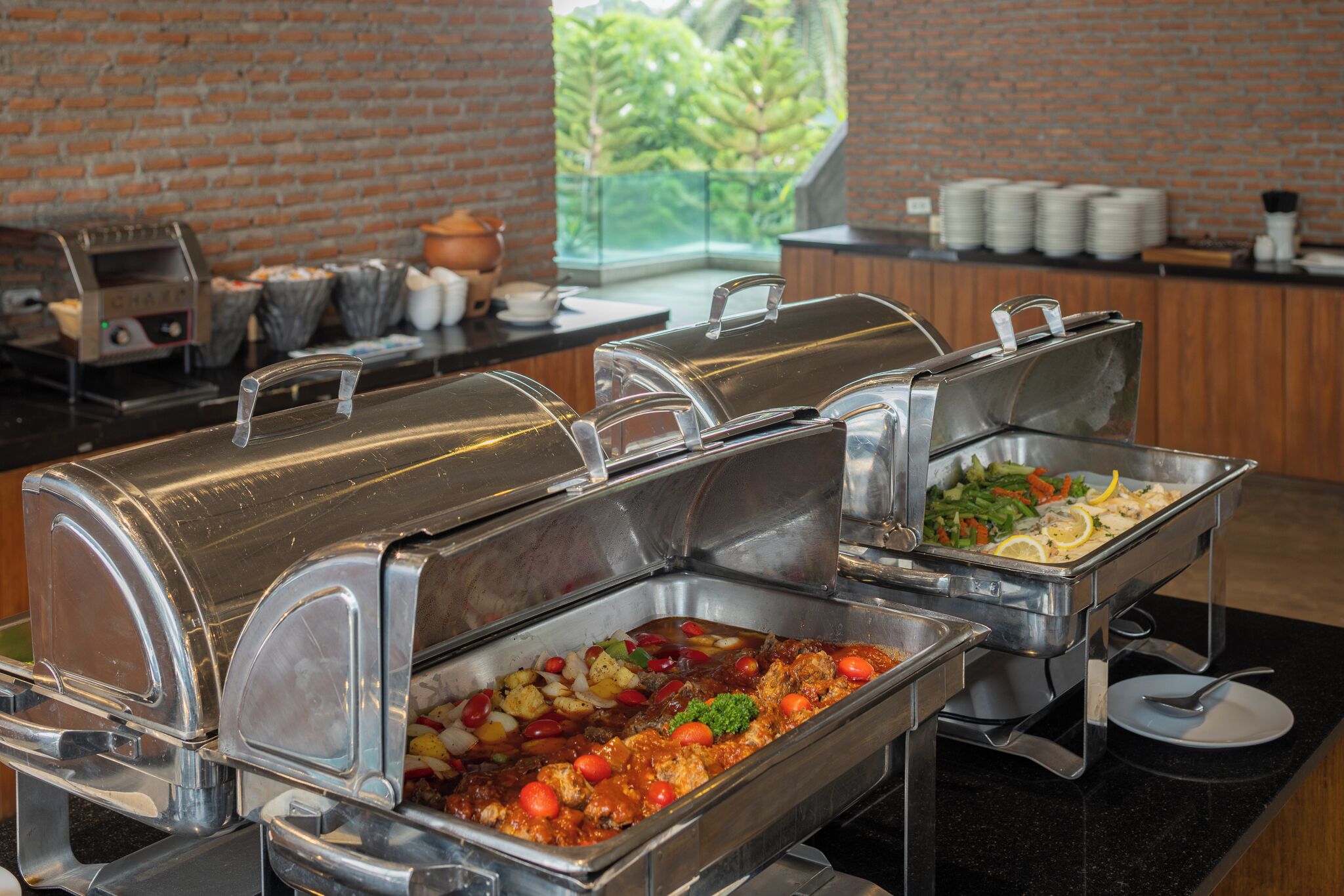 A buffet with various dishes, including pasta, vegetables, and meat.