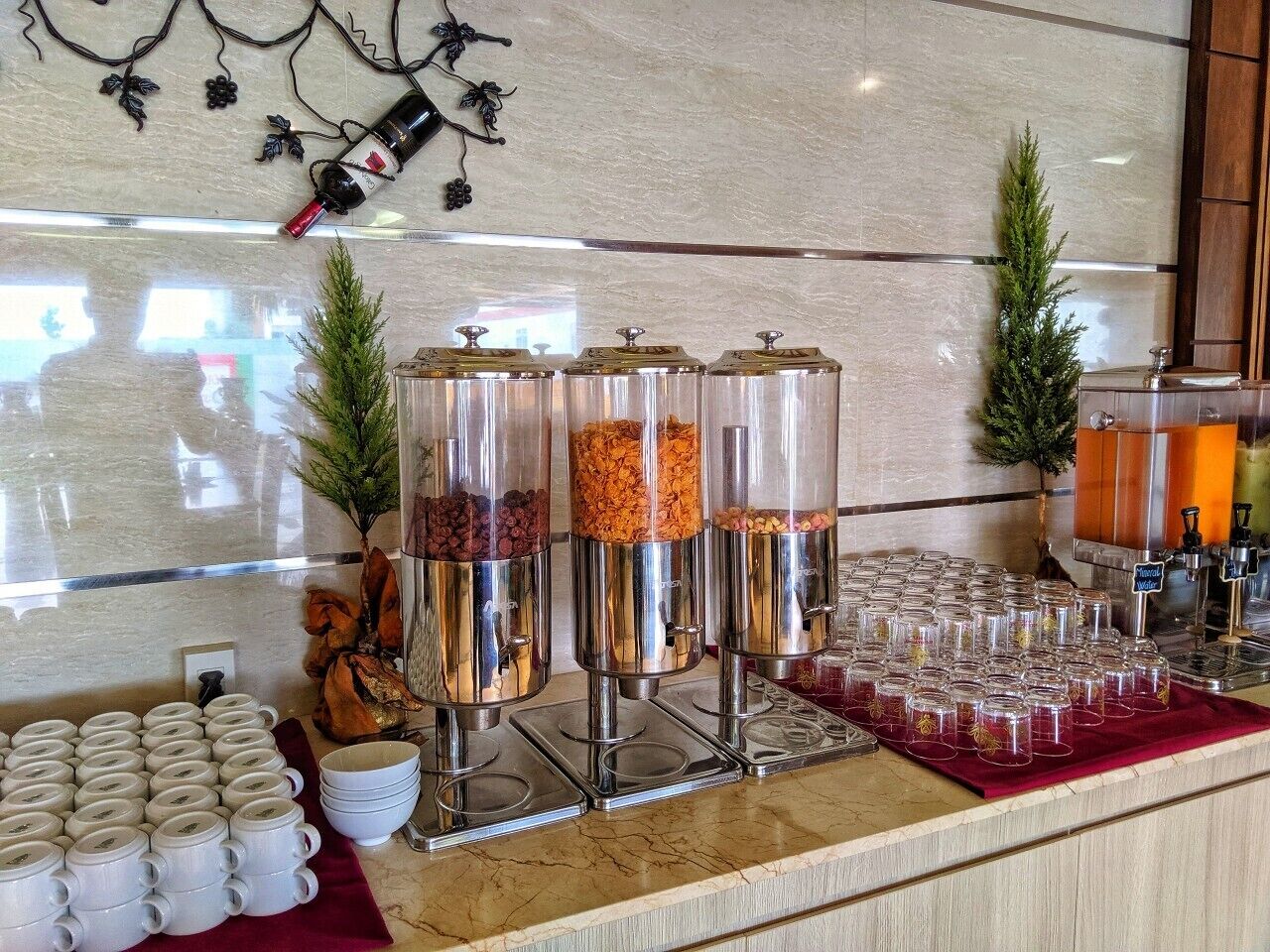 A buffet area with food dispensers, a coffee station, and a juice dispenser.