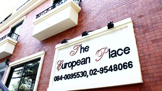 A sign for "The European Place" with contact information. - The European Place (Bangkok)
