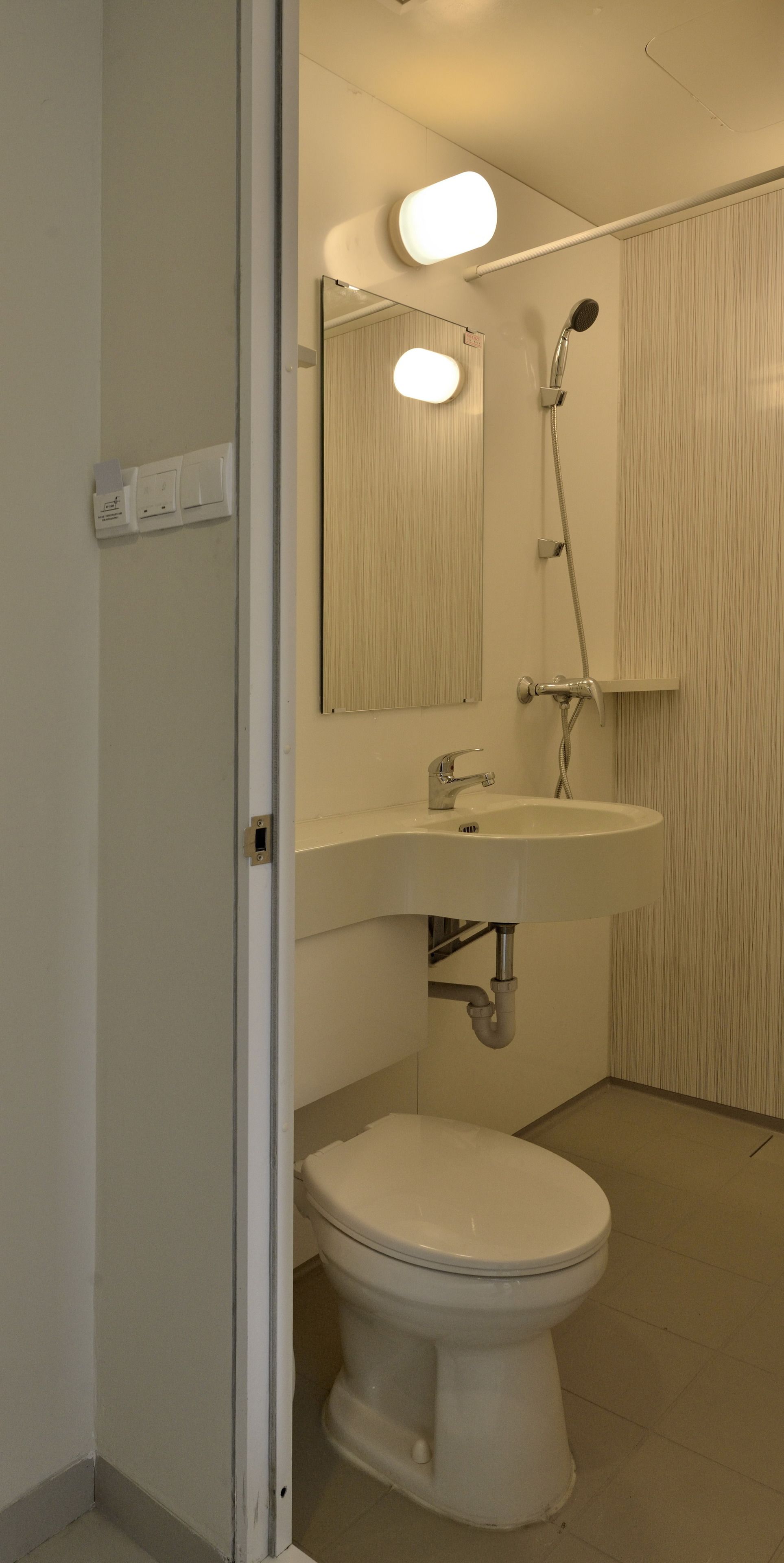 A bathroom with a toilet, sink, and shower.