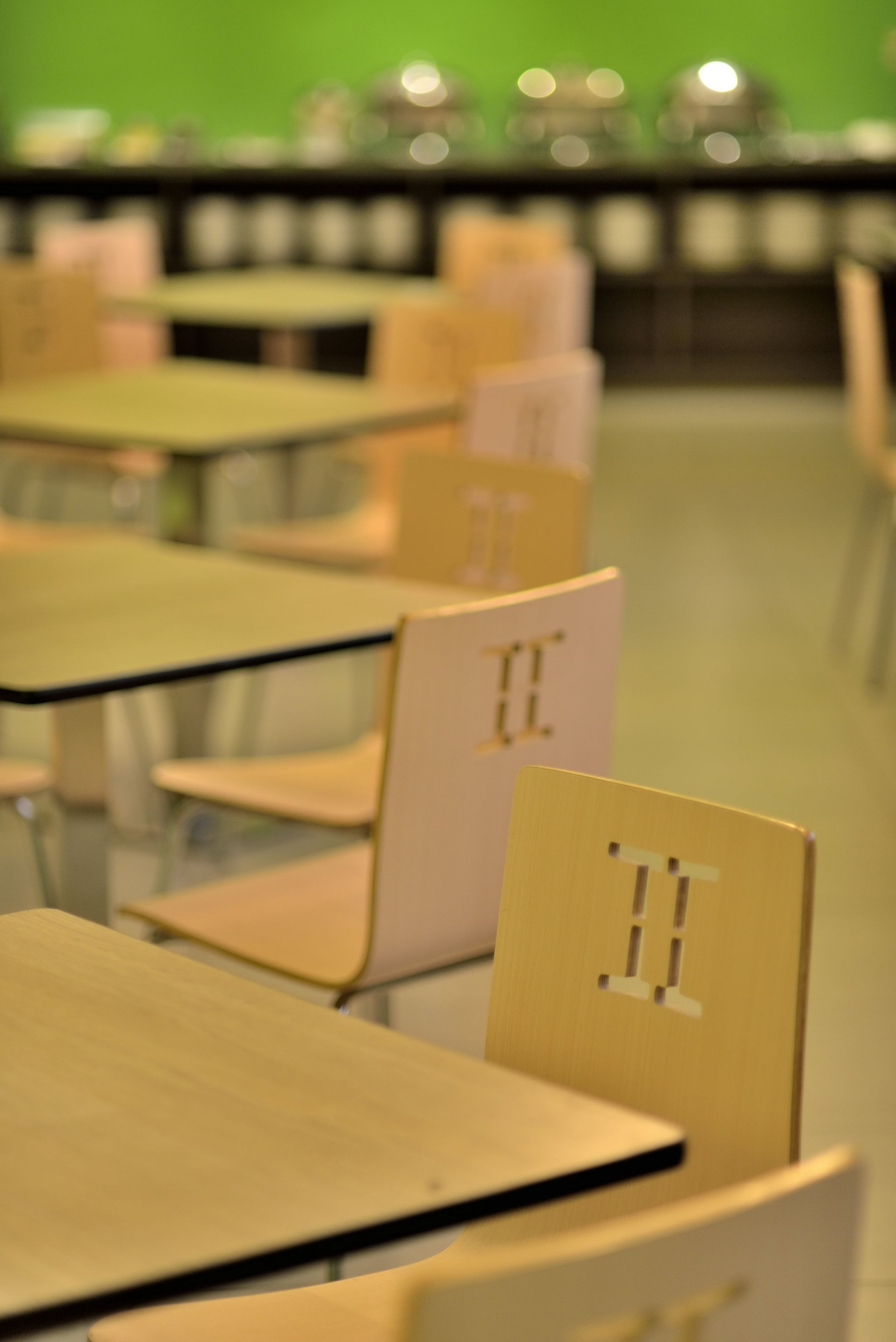 A classroom with desks and chairs, each marked with a number.