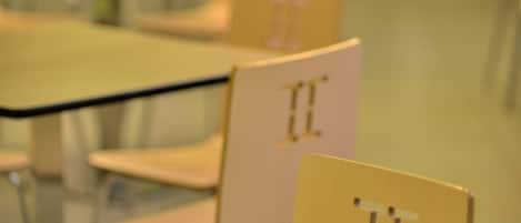 A classroom with desks and chairs, each marked with a number.