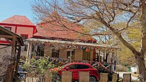 A building with a red roof and a porch. - Nikko Park Lodge Mountainside (Nikko)