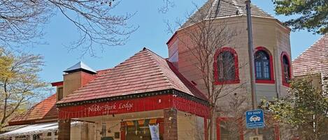 A building with a red roof, a tower, and a sign reading 'Nikko Park Lodge.'