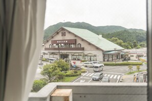 A building with a sign that reads 'TOYOTA' and a parking lot with several vehicles. - Nikko Park Lodge Tobu Station (Nikko)