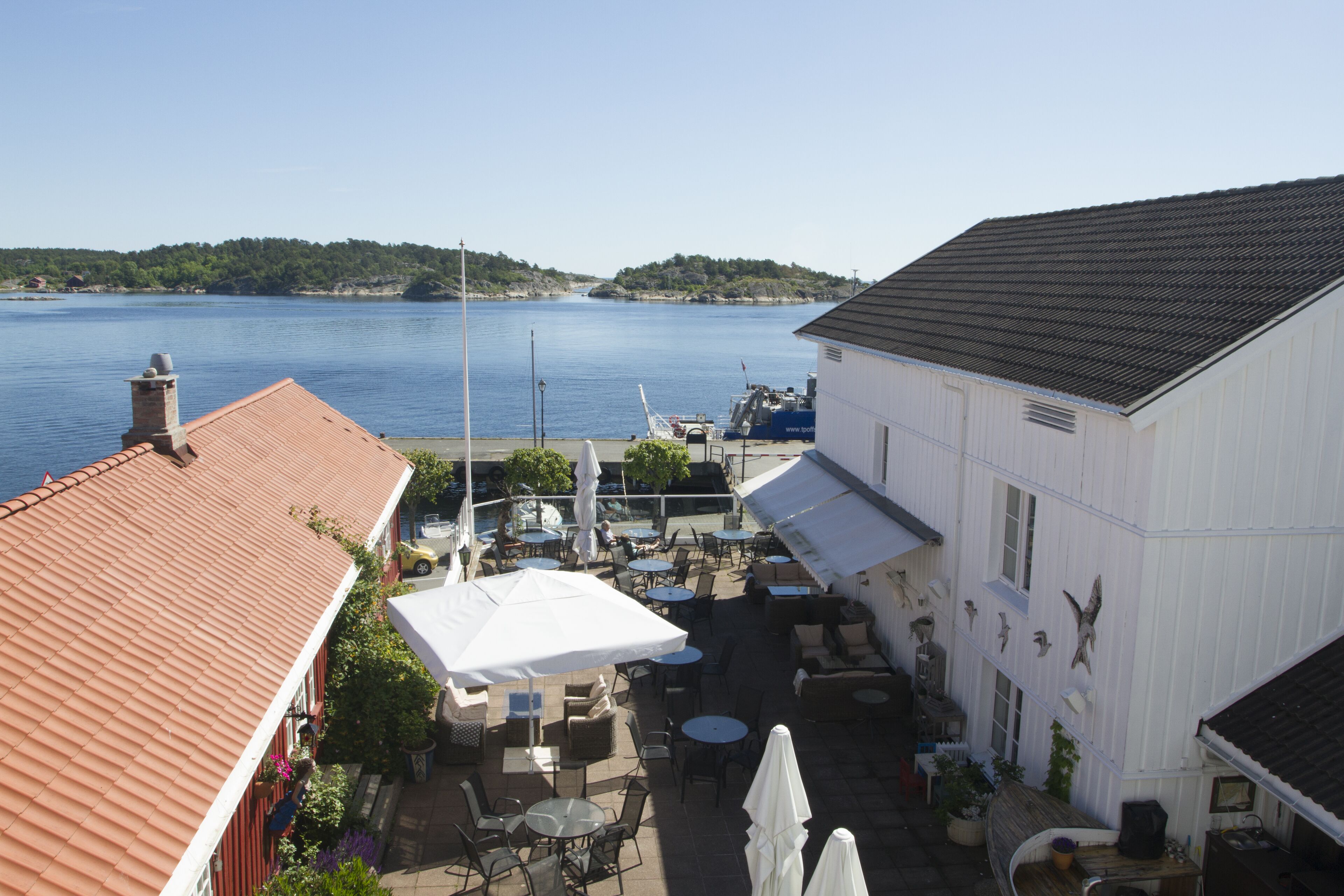 A waterfront property with outdoor seating, a boat dock, and a view of the water.