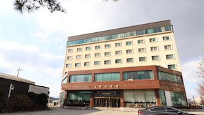 Un hotel de varios pisos con fachada moderna, grandes ventanales y una entrada destacada.