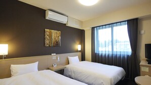 A hotel room with two beds, a nightstand, a desk, a TV, and a window with curtains. - Hotel Route-Inn Tome (Tome)