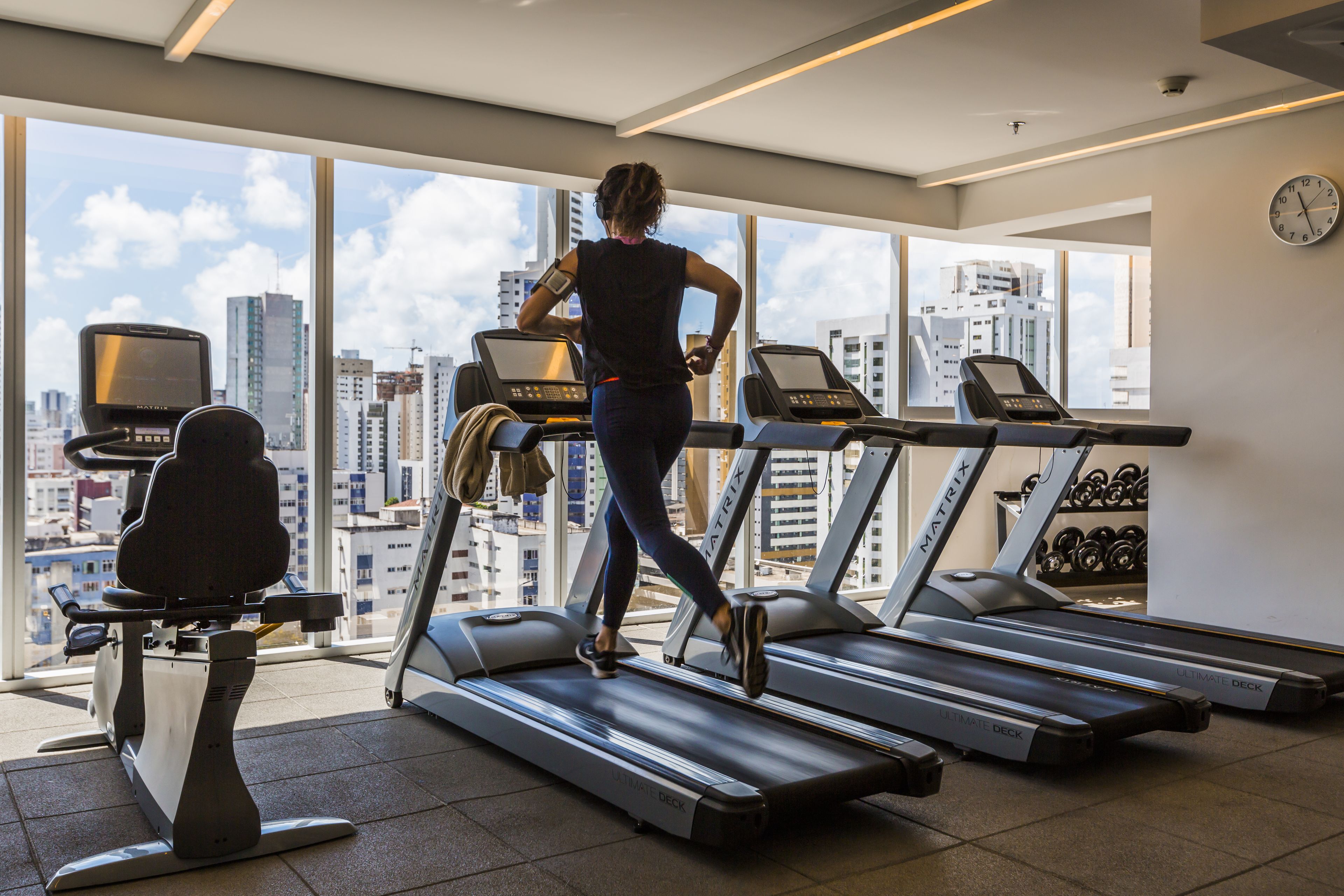 A gym with treadmills, a stationary bike, and a weight rack.