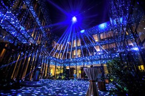 A modern building with a central open space and multiple levels of balconies. - Millennium Resort Hangzhou (Hangzhou)