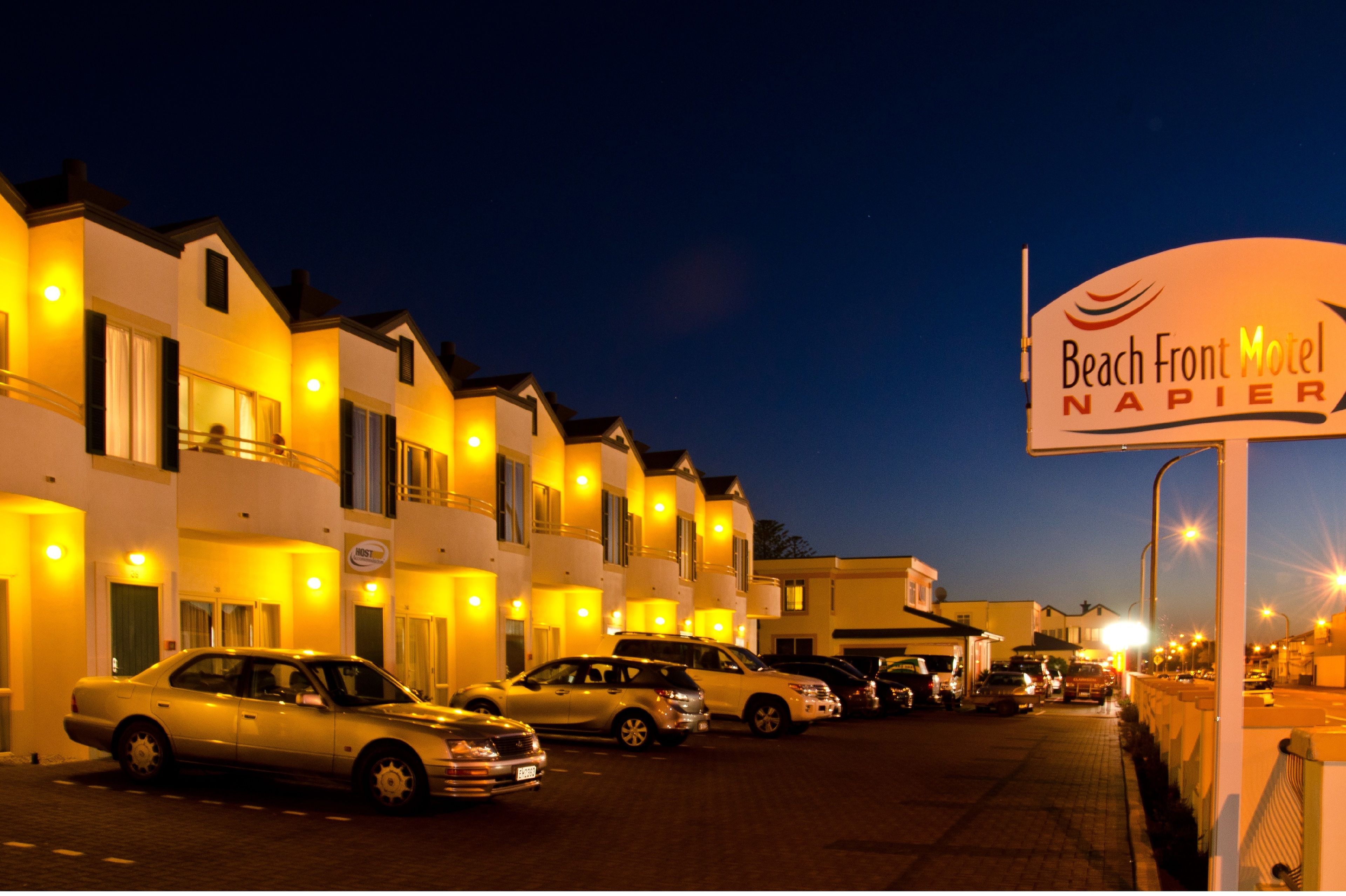 A row of hotel buildings with a sign for Beach Front Motel Napier.