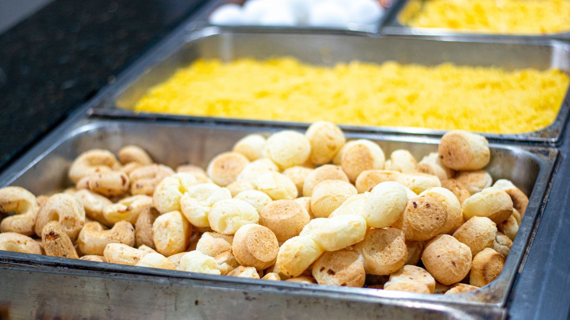 A buffet with various food items in metal containers.