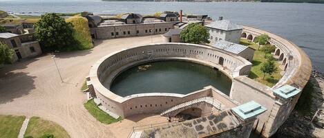 A historic fort with a central courtyard and a circular water feature.