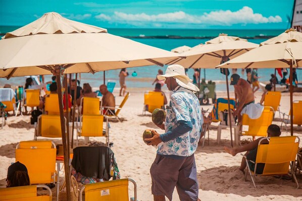 On the beach, sun-loungers, beach umbrellas, beach towels