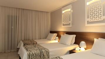 A hotel room with two beds, a wooden headboard, a telephone, and a wall-mounted light fixture.