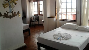 A hotel room with two beds, a chair, and a decorative wall piece. - Hotel Paraiso Escondido (Puerto Escondido)